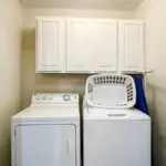 Private laundry room with washer dryer