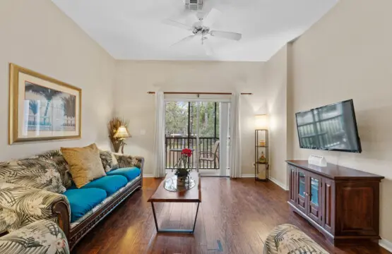 Bright and comfy living room with TV and easy patio access.