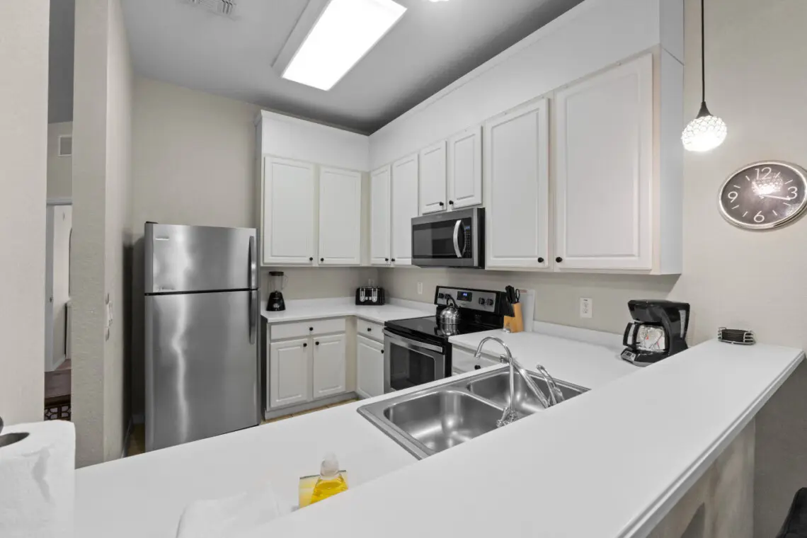 Fully equipped modern kitchen with stainless steel appliances