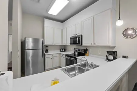 Fully equipped modern kitchen with stainless steel appliances