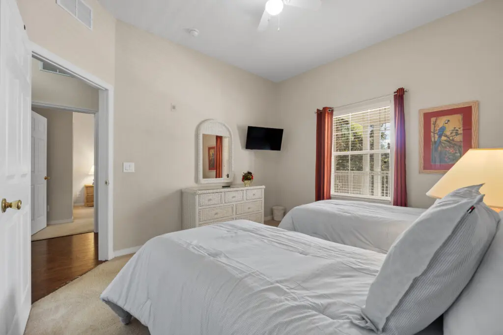 Simple and peaceful twin bedroom with soft lighting.