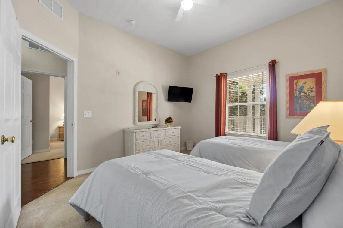 Simple and peaceful twin bedroom with soft lighting.