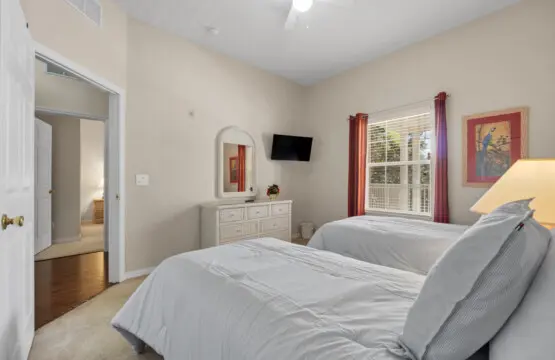 Simple and peaceful twin bedroom with soft lighting.