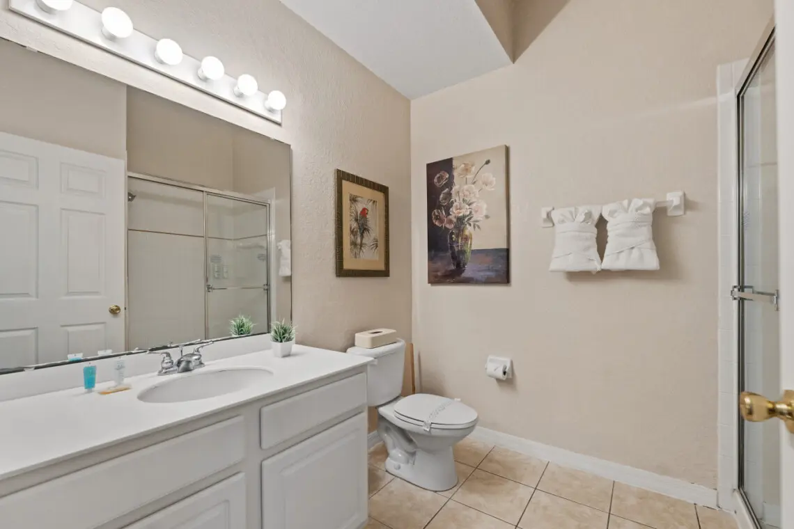 Spacious bathroom with double vanity and walk in shower.