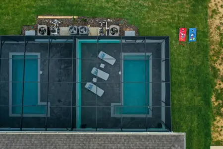 Private screened pool with lawn games