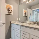 Spacious double-sink bathroom with artwork
