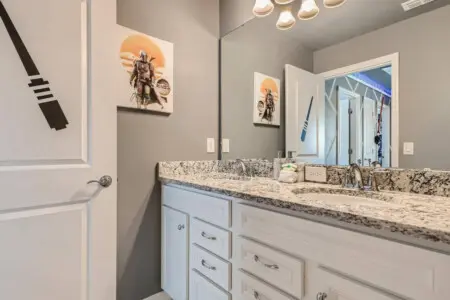 Spacious double-sink bathroom with artwork