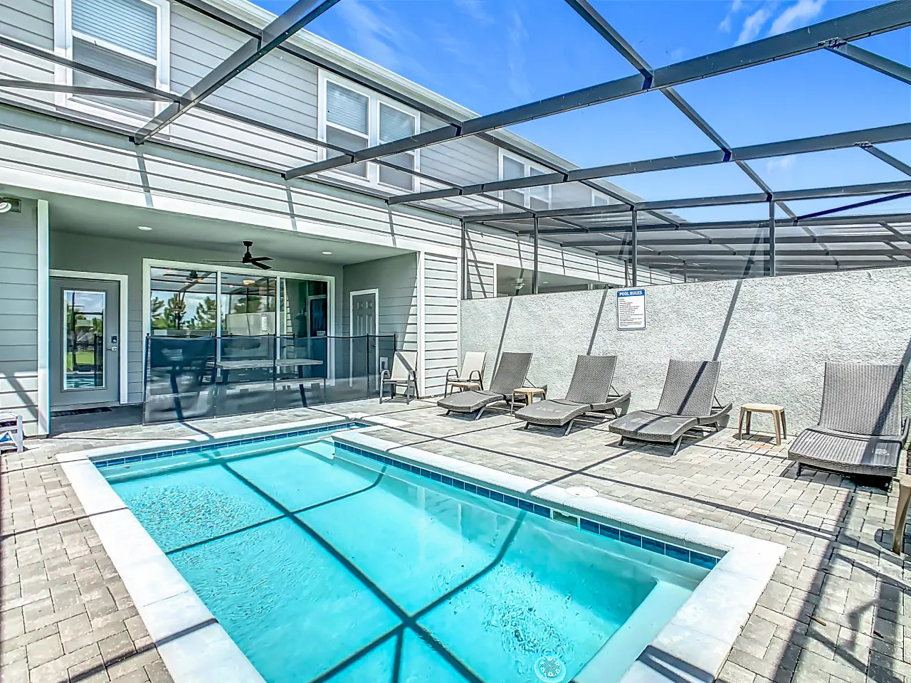 Private screened pool with lounge chairs