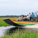 Group enjoying a high-speed airboat tour across Florida wetlands.