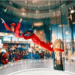 Instructor flying with participant inside iFLY Orlando tunnel